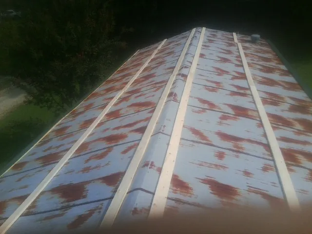 Rusted metal roof panels with new wood purlins before replacement — Storm Damage Roof Repair in Gulfport by Roofing Brothers